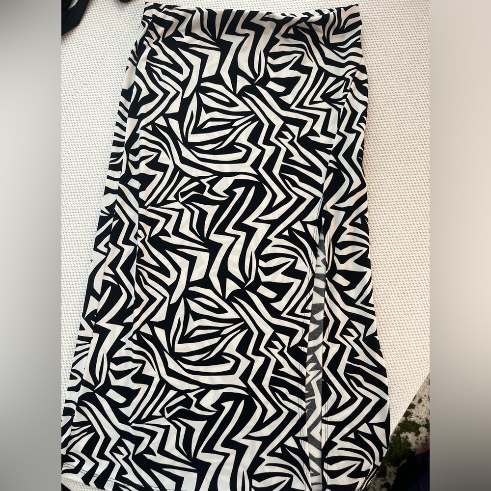 Patterned maxi skirt with a slit. Size medium but fits either small or medium!
